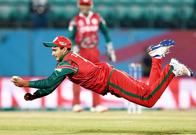 Oman Player Zeeshan Maqsoodof takes catch to dismiss Ireland's R Stirling