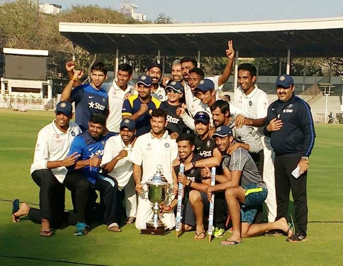 The Rest of India team with the Irani Cup after their come-from-behind victory over Mumbai