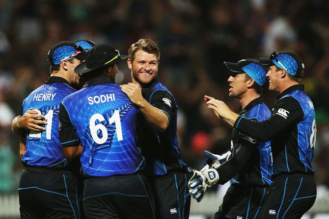 New Zealand all-rounder Corey Anderson celebrates a wicket with teammates