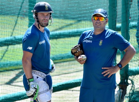 South African batsman AB de Villiers with team coach Russell Domingo during a practice session 