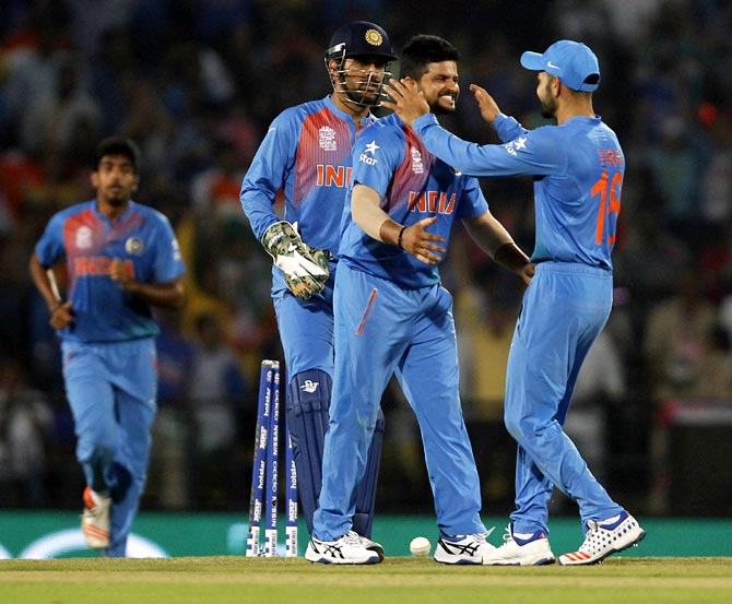 India's Suresh Raina (second right) is congratulated by his teammates 