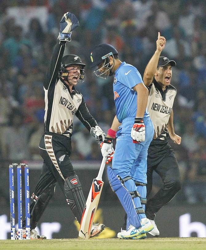  New Zealand wicketkeeper Luke Ronchi, left, and Ross Taylor, right, celebrate the dismissal of India's Yuvraj Singh 