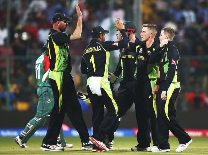 Australia's Adam Zampa is congratualted by teammates after taking the wicket of Bangladesh's Shuvagata Hom