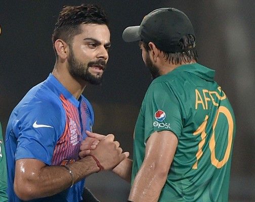 Indian batsman Virat Kohli being greeted by Pakistan captain Shahid Afridi