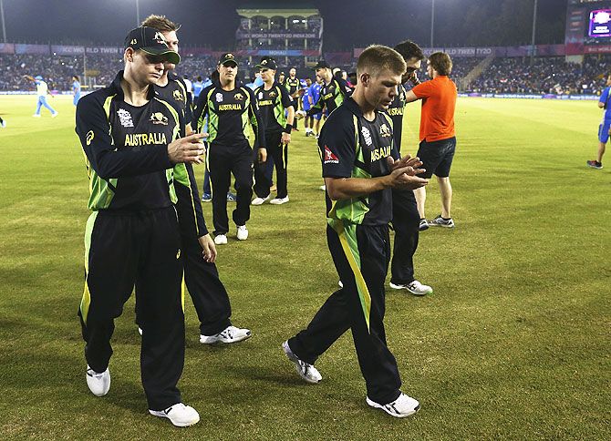 Australia players wear a dejected look after their match against India in Mohali on Sunday