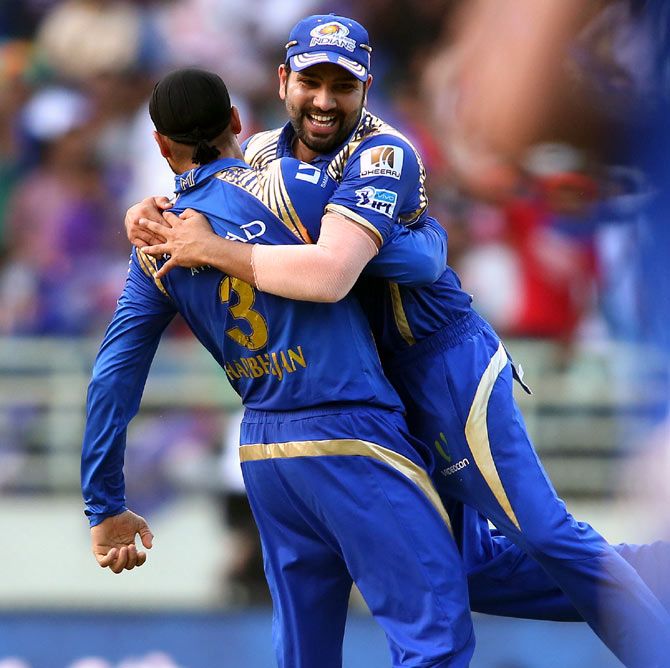Harbhajan Singh, left, and Rohit Sharma celebrate the wicket of Kane Williamson