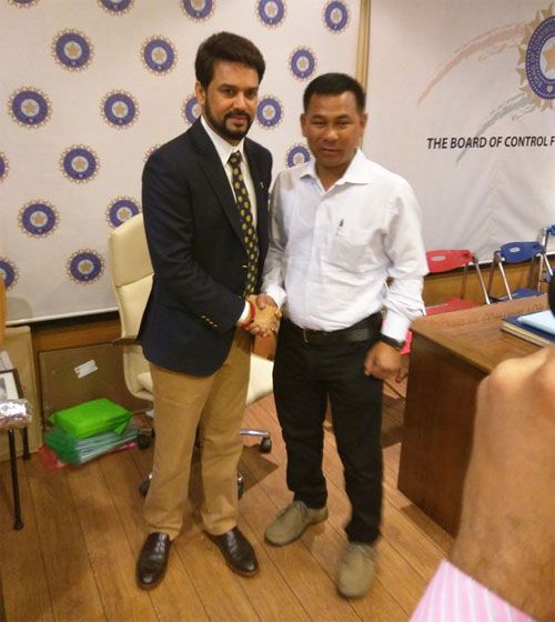 Newly elected BCCI President, Anurag Thakur (left) is congratulated by a board member