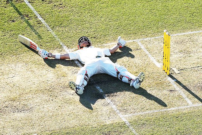 Australia's David Warner lies on the pitch after slipping while playing a shot