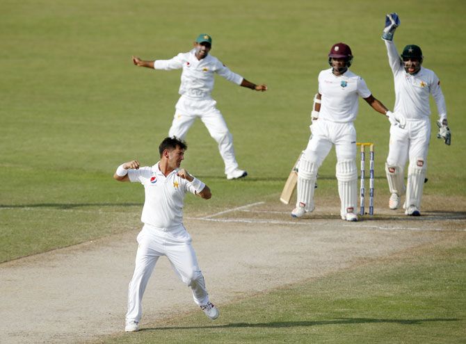 Pakistan's Yasir Shah takes the wicket of West Indies' Leon Johnson