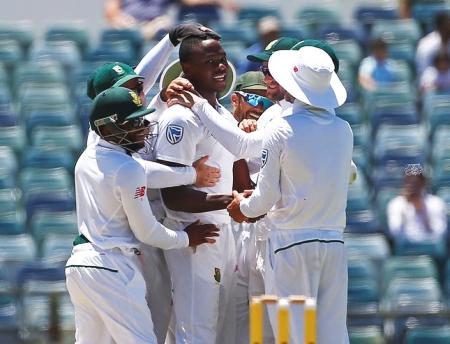 South Africa's Kagiso Rabada celebrates with team mates after dismissing Australia's Mitchell Starc at the WACA Ground in Perth on Monday