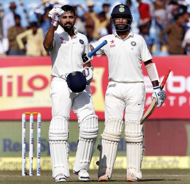 Murali Vijay, left, celebrates after completing his century with Cheteshwar Pujara on Day 3