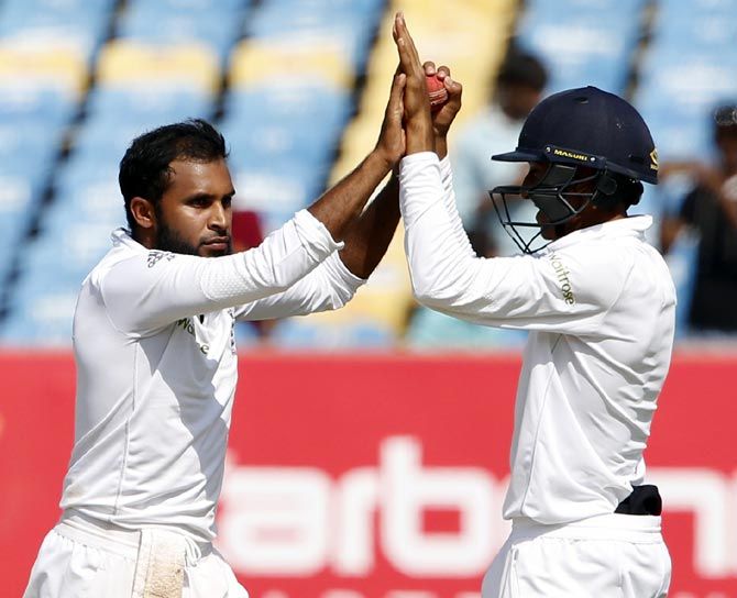 England's Adil Rashid (left), celebrates with teammate Haseeb Hameedthe after scalping the wicket of India's Ravindra Jadeja during the first Test in Rajkot. The England spinners could play at pivotal role in the 2nd Test in Vizag