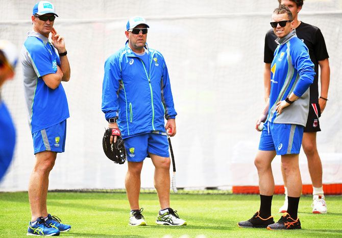 Australia's batting coach Greame Hick chats with coach Darren Lehmann and pacer Peter Siddle during an Australian nets session at Adelaide Oval in Adelaide on Monday