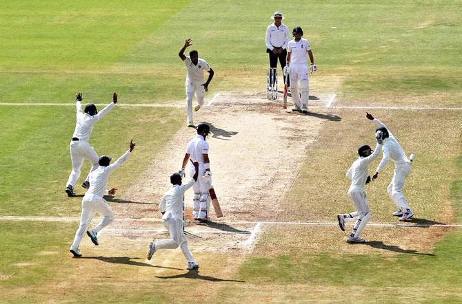 India's Ravichandran Ashwin celebrates with teammates after the dismissal of England's Ben Duckett on Monday