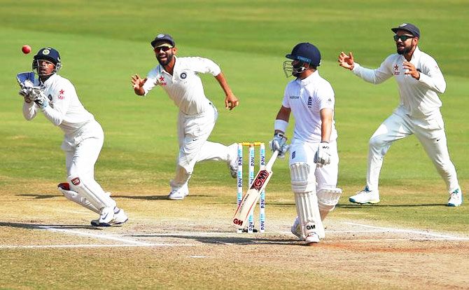 India's Wriddhiman Saha (left) takes a catch to dismiss England's Ben Duckett on Day 5 of the 2nd Test in Vizag on Monday