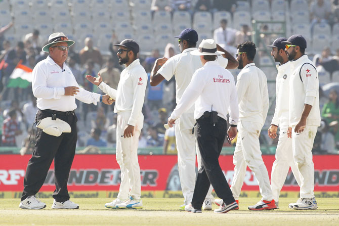 India captain VIrat Kohli has a chat with umpire Marais Erasmus after the dismissal of England's Ben Stokes on Saturday