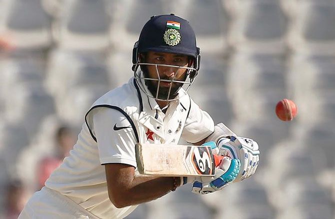 India's Cheteshwar Pujara plays a shot during his innings on Sunday