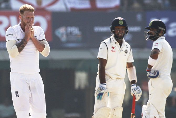 Ben Stokes gestures as Cheteshwar Pujara and Virat Kohli bat on Day 2 of the Mohali Test on Sunday