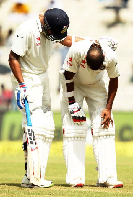 Shikhar Dhawan (right) is comforted by teammate Rohit Sharma after getting hit on the thumb, on Day 3 of the 2nd Test in Kolkata on Sunday