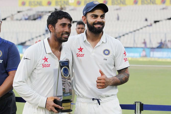 India captain Virat Kohli with teammate and man-of-the-match Wriddhiman Saha after the 2nd Test match on Monday