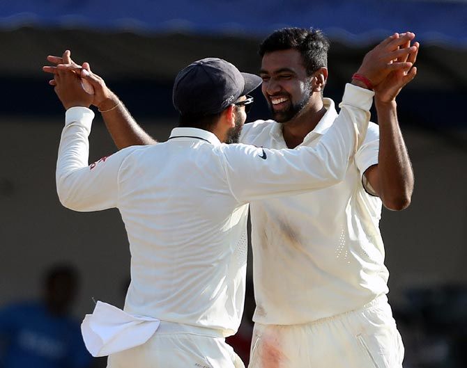 R Ashwin and captain Virat Kohli celebrate the wicket of Matt Henry