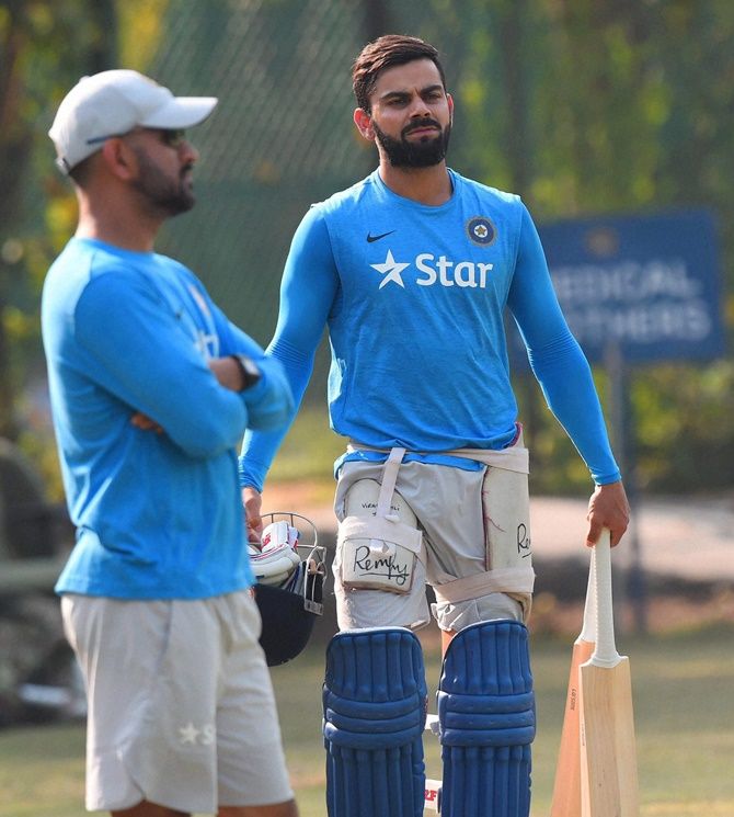Virat Kohli (background) says he is confident of leading the ODI and T20I teams