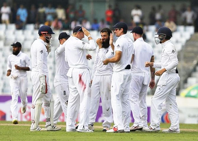England's players celebrate the dismissal of Bangaldesh's captain Mushfiqur Rahim on Day 1 of the 2nd Test at Sher-e-Bangla Stadium, Dhaka, Friday