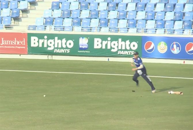 A video grab of Liam Thomas hopping to field the ball even as he loses his prosthetic limb