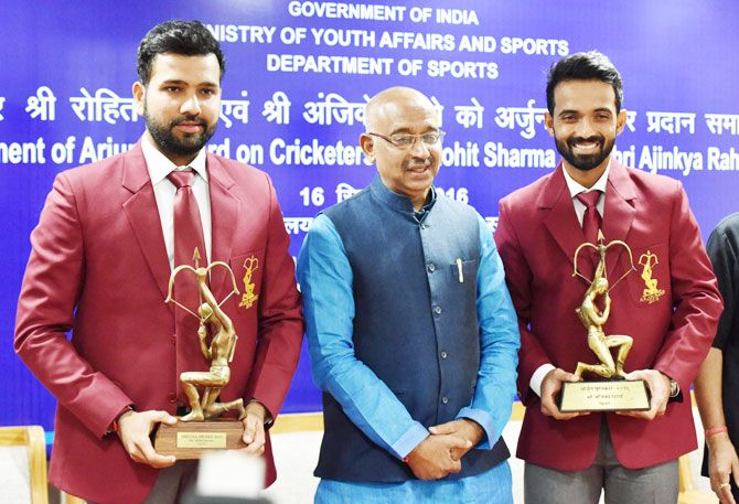 Cricketers Rohit Sharma (left) and Ajinkya Rahane (right) with Union Minister of State (I/C) for Youth Affairs & Sports Vijay Goel after being conferred with Arjuna Awards at a function in New Delhi on Friday