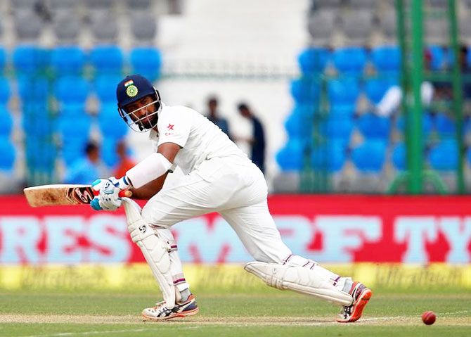 India's Cheteshwar Pujara plays a shot on Day 1 of the first Test against New Zealand in Kanpur on Thursday