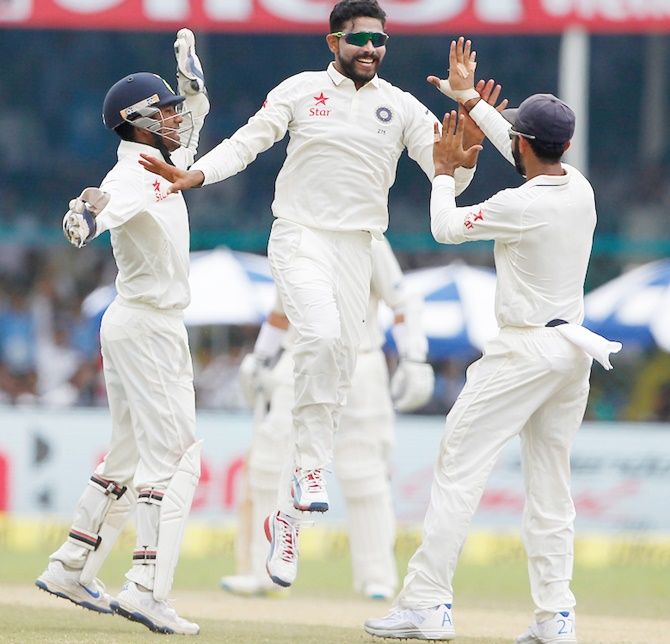 Ravindra Jadeja of India celebrates a wicket with teammates