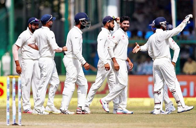 India's Ravindra Jadeja celebrates with teammates after taking the wicket of New Zealands's Luke Ronchi