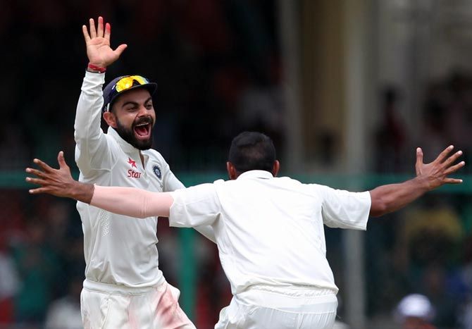India captain Virat Kohli celebrates a wicket with Mohammad Shami on Day 5 of the first Test in Kanpur on Monday