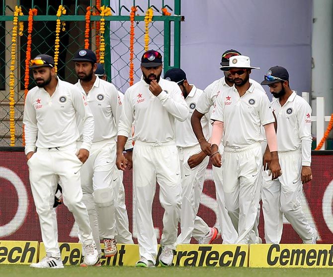 India captain Virat Kohli (left) leads his team out of the dressing room
