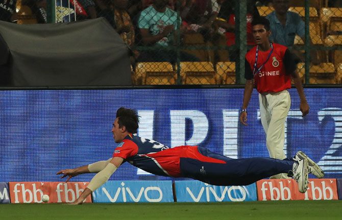 Delhi Daredevils' Pat Cummins goes full stretch as he fields the ball on the boundary