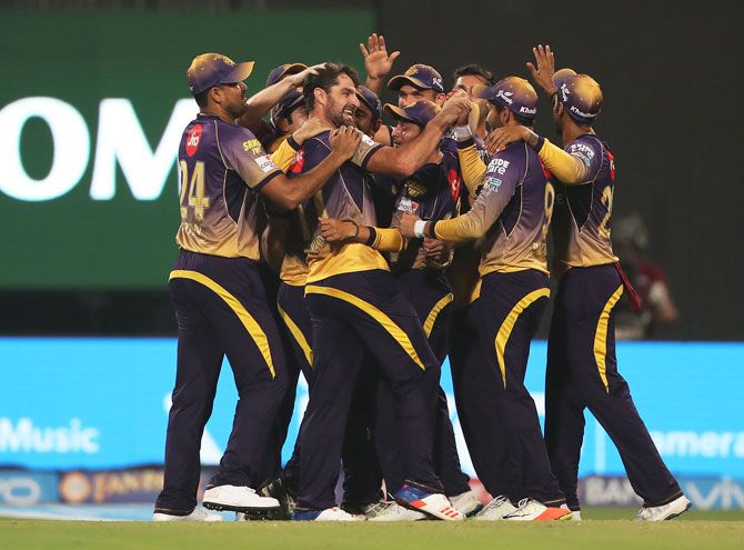KKR players celebrate with bowler Colin de Grandhomme after he dismissed RCB's Yuzvendra Chahal and record the 82-run win at the Eden Gardens on Sunday