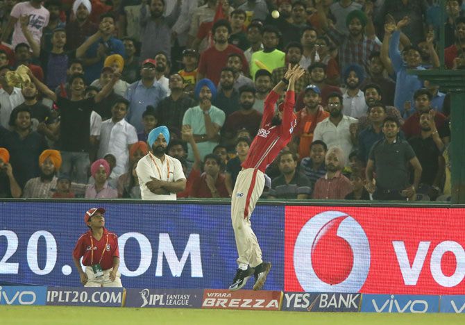 Kings XI Punjab's Manan Vohra prevents a six with his athletic fielding 