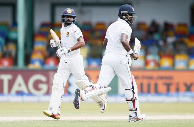 Sri Lanka's Angelo Mathews and Niroshan Dickwella run between wickets