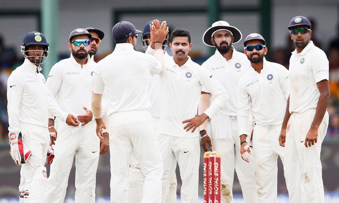 India's Ravindra Jadeja celebrates with his teammates after taking the wicket of Sri Lanka's Dimuth Karunaratne on Sunday