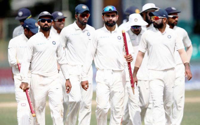 India's captain Virat Kohli and teammates walk off the field after winning the 2nd Test match in Colombo on Saturday