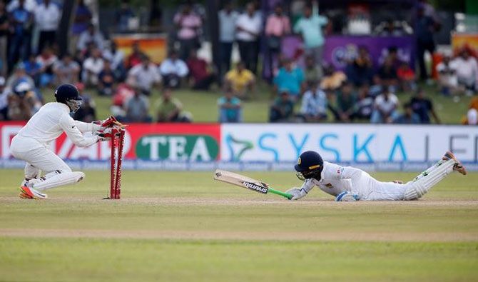 Sri Lanka's Upul Tharanga is run out by India's wicketkeeper Wriddhiman Saha during the first Test in Galle