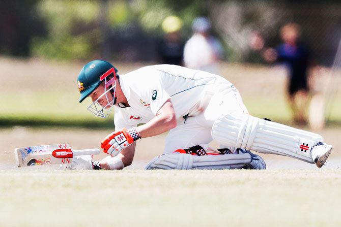 David Warner goes to the ground after being hit on the neck by a Josh Hazlewood bouncer during Day 2 of the Australian Test cricket inter-squad match at Marrara Cricket Ground in Darwin on Tuesday