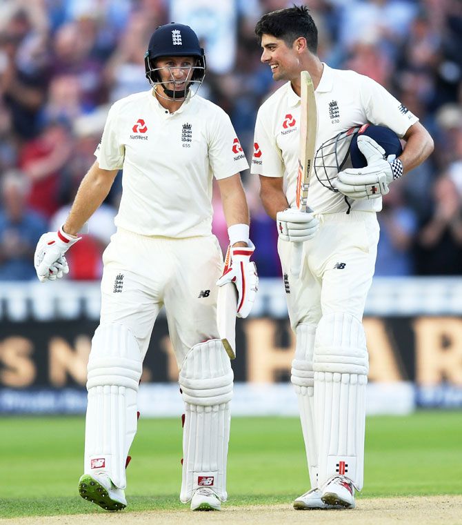 England's Alastair Cook celebrates with captain Joe Root after reaching his century during the 1st Test against West Indies at Edgbaston in Birmingham, England, on Thursday
