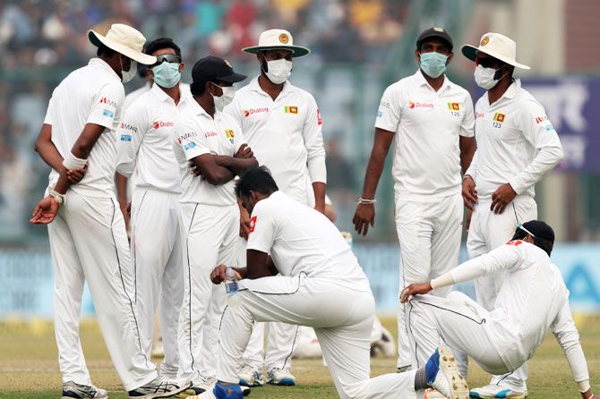 Sri Lanka fielders in masks looked concerned as bowler Lahiru Gamage (kneeling, left) takes a break from bowling
