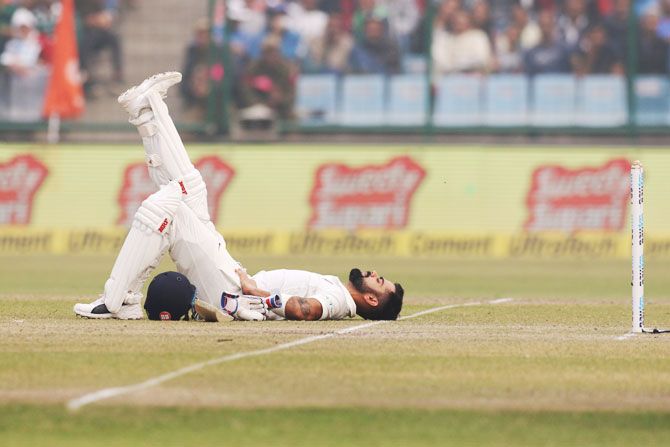 India captain Virat Kohli stretches during the first interruption of play on Day 2 of the 3rd Test against Sri Lanka in New Delhi on Sunday