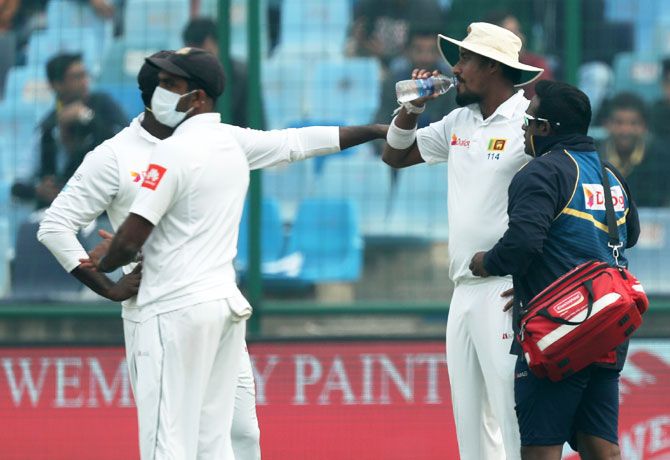 Sri Lanka pacer Suranga Lakmal is attended to by the team physio after throwing up on Day 4 of the 3rd Test in New Delhi on Monday