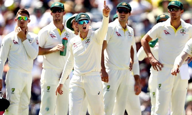 Australia captain Steve Smith signals to Mark Stoneman of England after he began to walk back to the middle after being dismissed by Mitchell Starc
