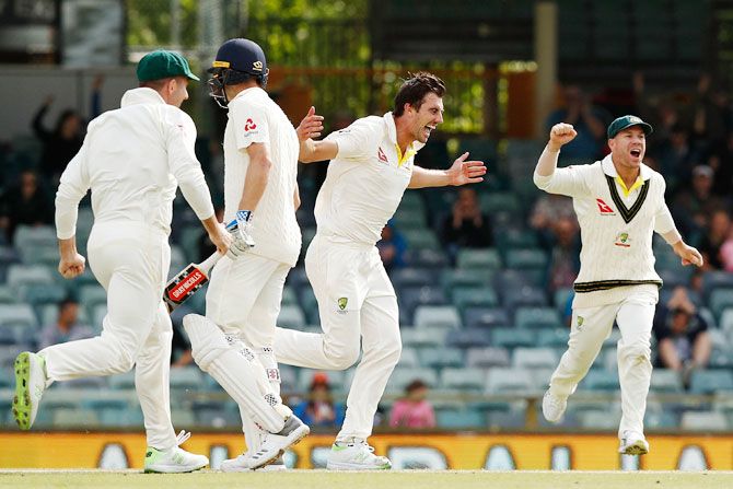 Australia's Pat Cummins celebrates the final wicket of England's Chris Woakes to help Australia reclaim the Ashes 