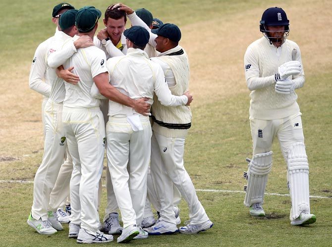 Australia's players celebrate as Jonny Bairstow walks back after his dismissal