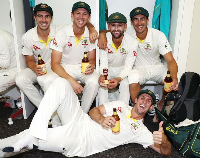 Australia bowlers Pat Cummins, Josh Hazlewood, Nathan Lyon Mitchell Starc and Mitch Marsh celebrate in the changerooms after the team's Ashes win over England at WACA in Perth on Monday